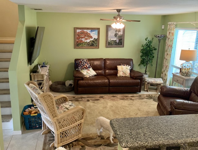 living room with ceiling fan and light tile patterned flooring