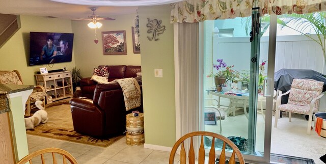 living room featuring ceiling fan and light tile patterned floors