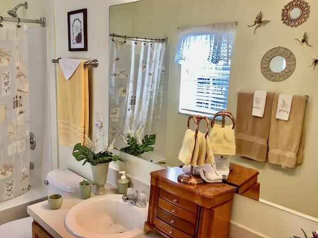 full bathroom featuring toilet, vanity, and shower / bath combination with curtain