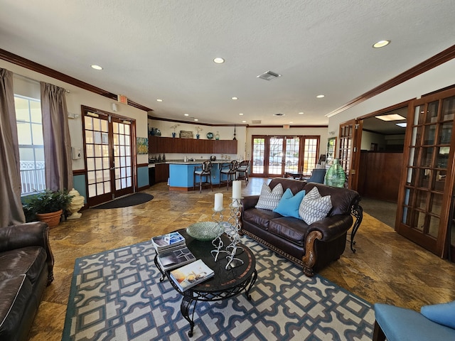 living room with french doors, a textured ceiling, and crown molding