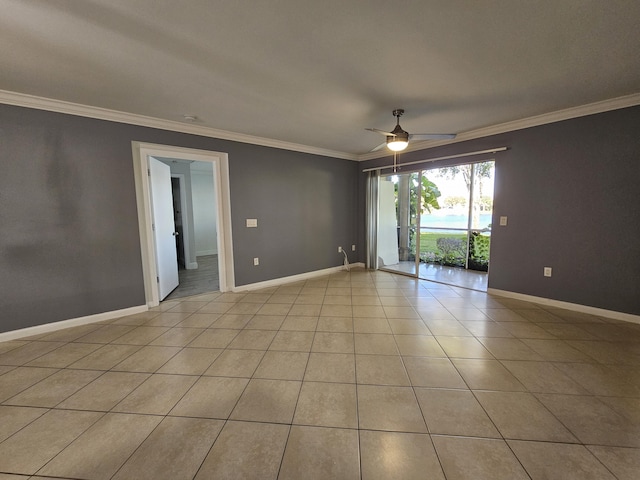 tiled empty room featuring ceiling fan and ornamental molding