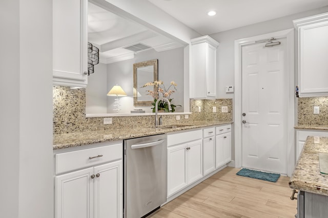 kitchen with white cabinetry, stainless steel dishwasher, and tasteful backsplash