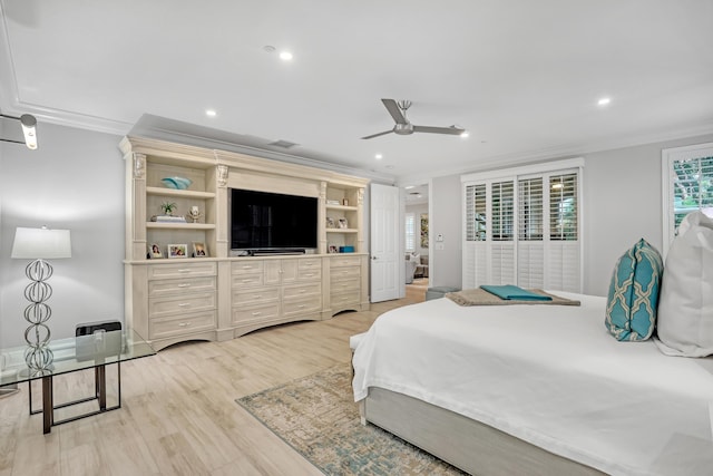 bedroom featuring ornamental molding, ceiling fan, and light hardwood / wood-style flooring