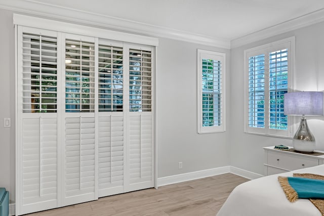 bedroom featuring light hardwood / wood-style flooring and ornamental molding