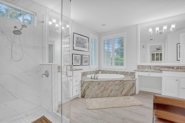 bathroom with vanity and independent shower and bath