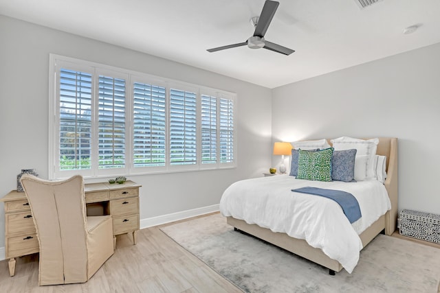 bedroom with ceiling fan and light hardwood / wood-style floors