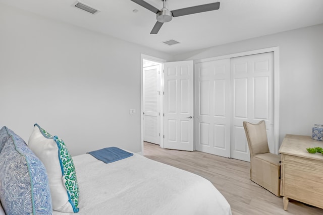 bedroom featuring ceiling fan, a closet, and light wood-type flooring