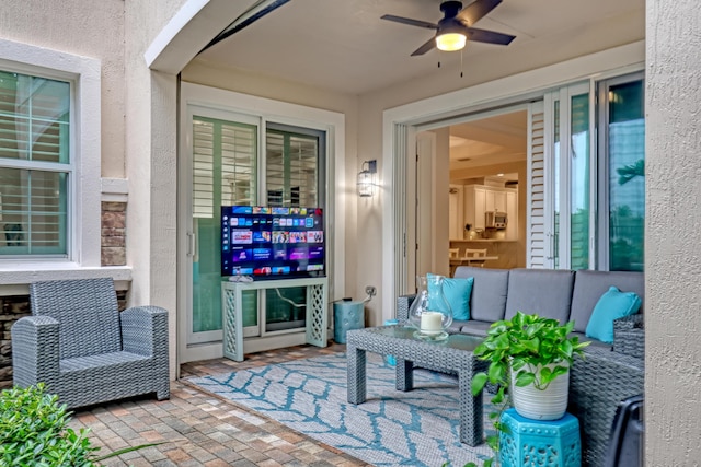 view of patio with an outdoor living space and ceiling fan