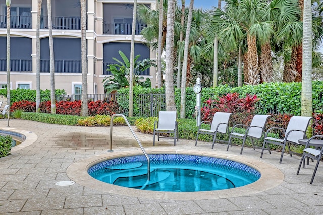 view of pool featuring a community hot tub and a patio