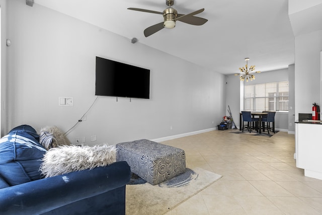 tiled living room with sink and ceiling fan with notable chandelier