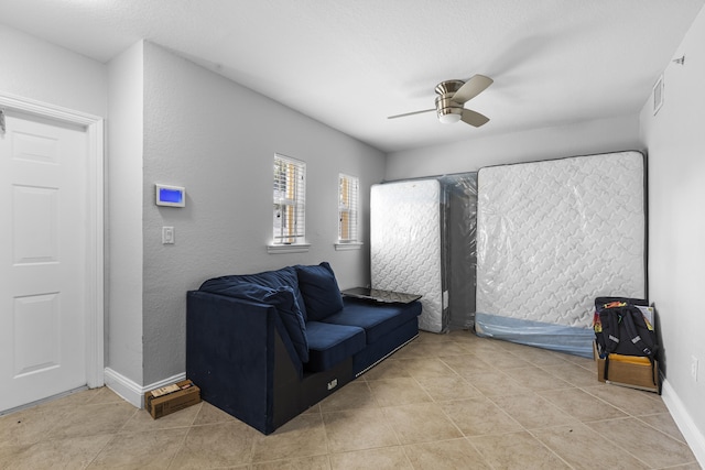 sitting room featuring light tile patterned flooring and ceiling fan