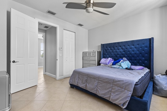 tiled bedroom with a closet and ceiling fan