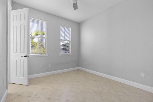 spare room featuring light tile patterned flooring and ceiling fan