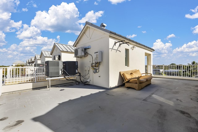 view of property exterior with cooling unit and a patio