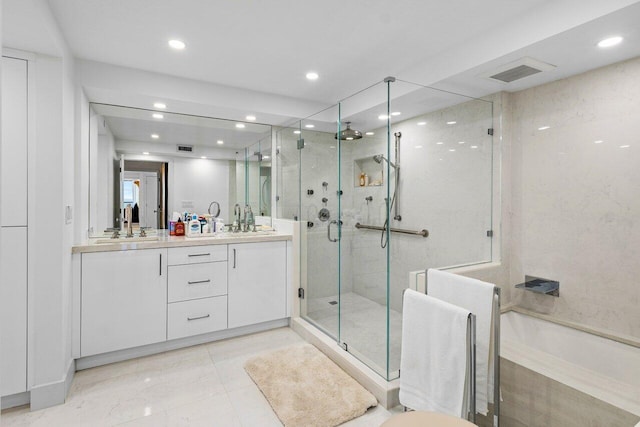 bathroom featuring shower with separate bathtub and vanity