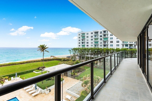 balcony with a water view and a beach view