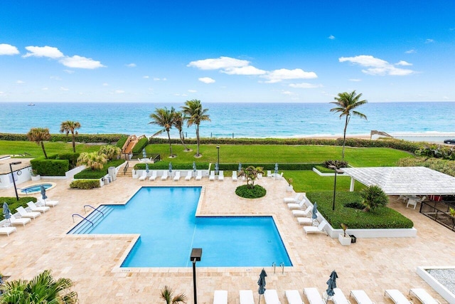 view of pool featuring a water view, a patio area, and a community hot tub