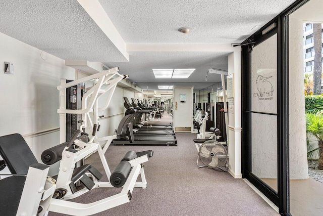 gym featuring a textured ceiling