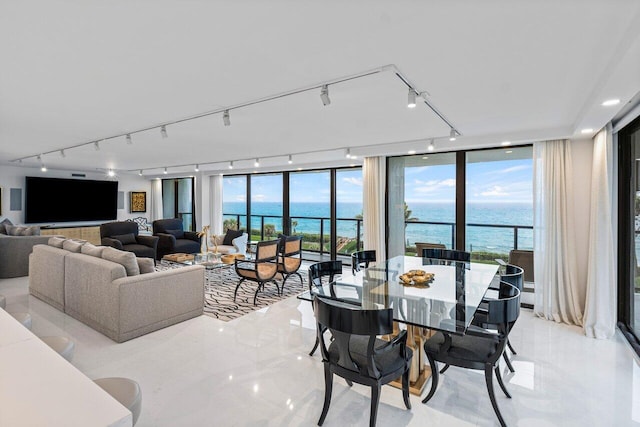 living room with a wall of windows and a water view