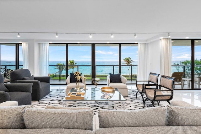 living room featuring a wealth of natural light and a water view