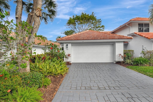 mediterranean / spanish home featuring a garage