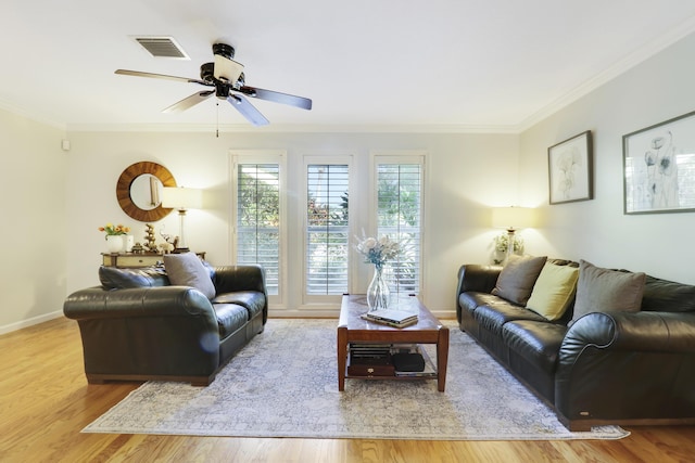 living room featuring ceiling fan, crown molding, and light wood-type flooring