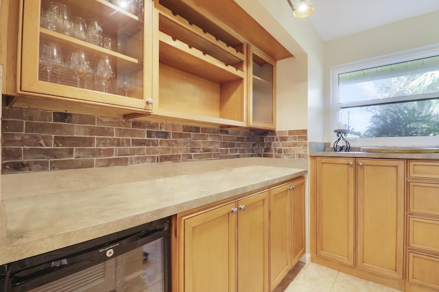 kitchen featuring light tile patterned flooring, wine cooler, and backsplash