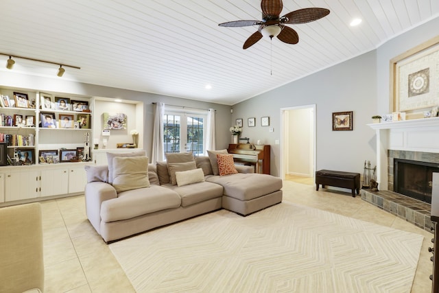 living room with ceiling fan, a tile fireplace, wood ceiling, and light tile patterned flooring