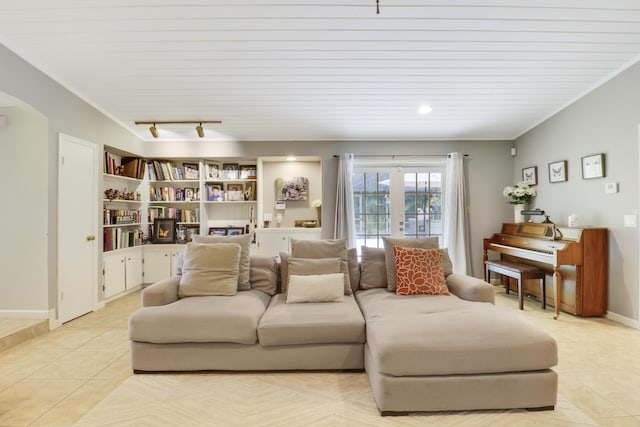 tiled living room with french doors and track lighting