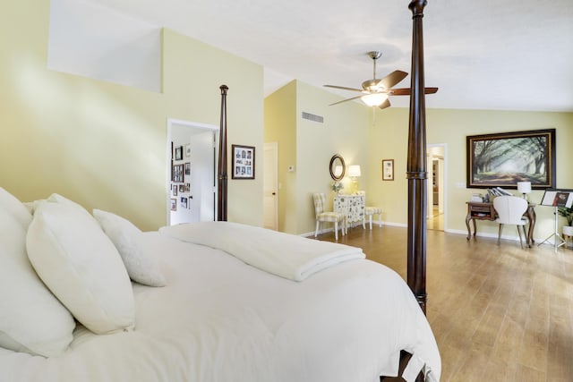 bedroom with ceiling fan, lofted ceiling, and light hardwood / wood-style floors