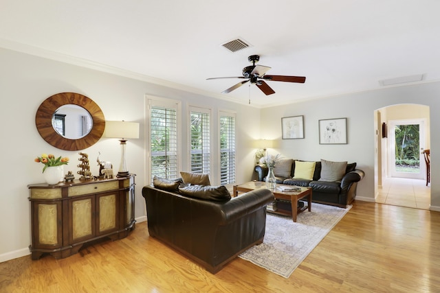 living room featuring ceiling fan, crown molding, and light hardwood / wood-style floors