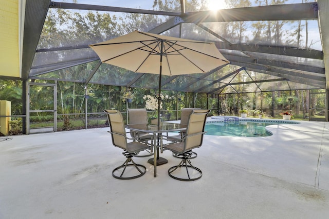 view of swimming pool featuring a patio area and glass enclosure