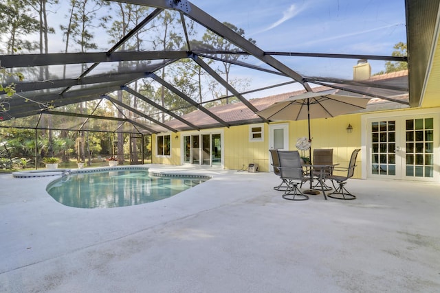 view of pool featuring a lanai, french doors, and a patio area