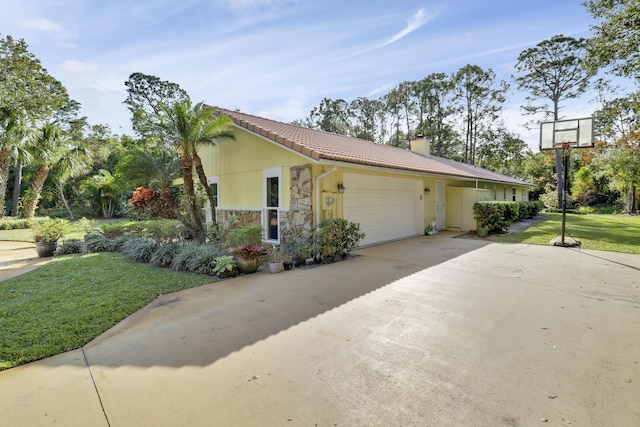 view of side of property featuring a garage and a yard