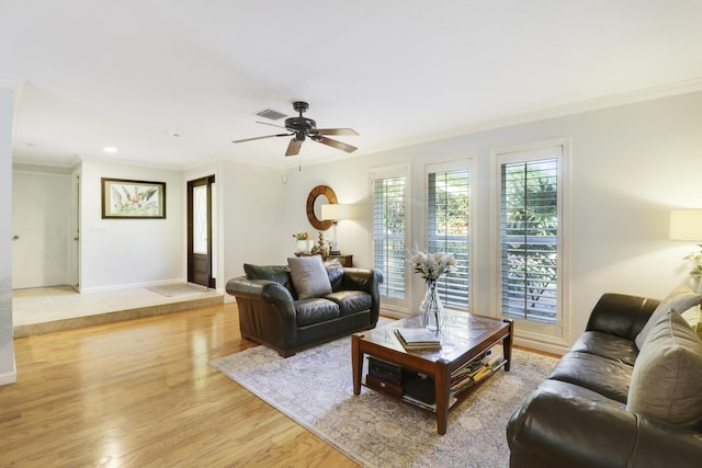 living room featuring ceiling fan, crown molding, and light hardwood / wood-style flooring