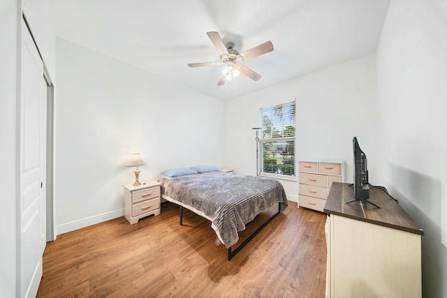 bedroom with ceiling fan, hardwood / wood-style floors, and a closet