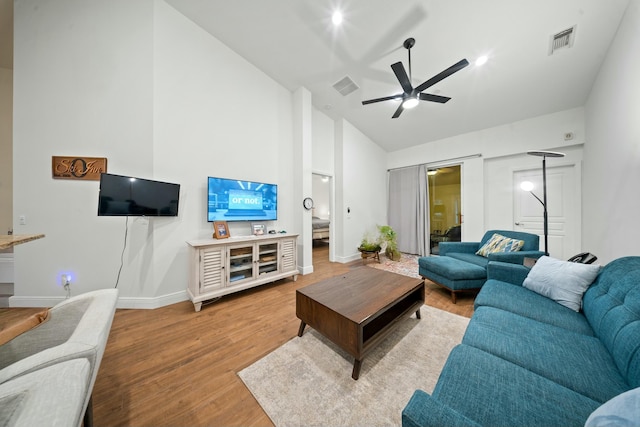 living room with ceiling fan, hardwood / wood-style flooring, and high vaulted ceiling