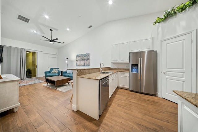 kitchen featuring white cabinets, appliances with stainless steel finishes, sink, kitchen peninsula, and ceiling fan