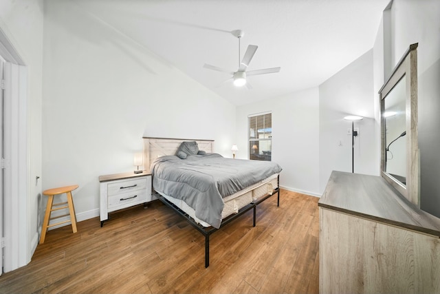 bedroom featuring ceiling fan, wood-type flooring, and vaulted ceiling