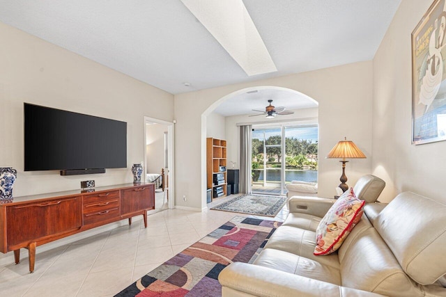 tiled living room featuring a textured ceiling and ceiling fan