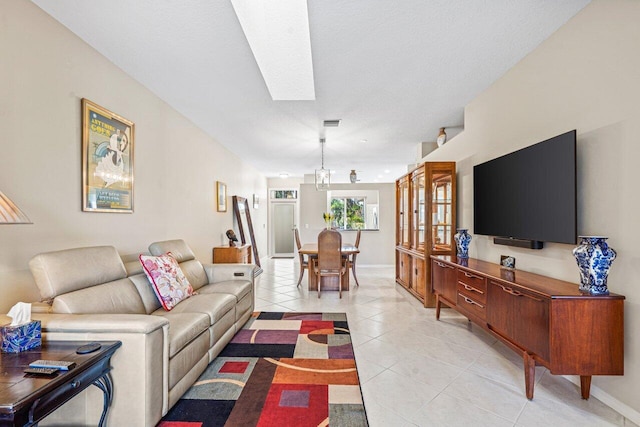 tiled living room with a skylight