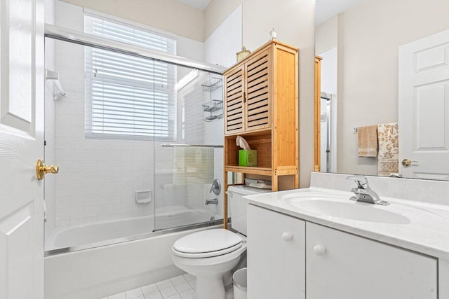 full bathroom with vanity, tile patterned floors, shower / bath combination with glass door, and toilet