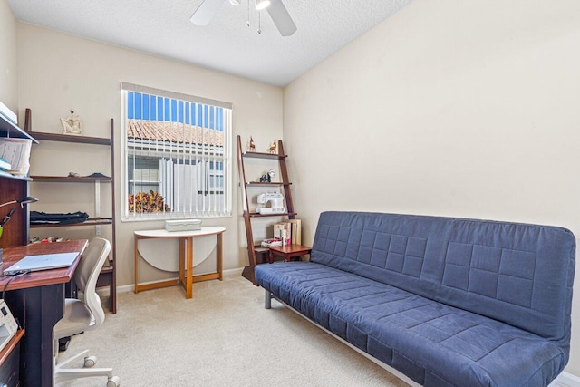 office featuring ceiling fan, carpet, and a textured ceiling