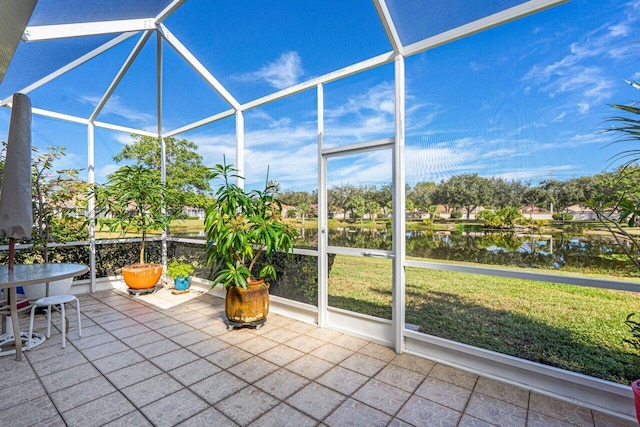 unfurnished sunroom with a water view