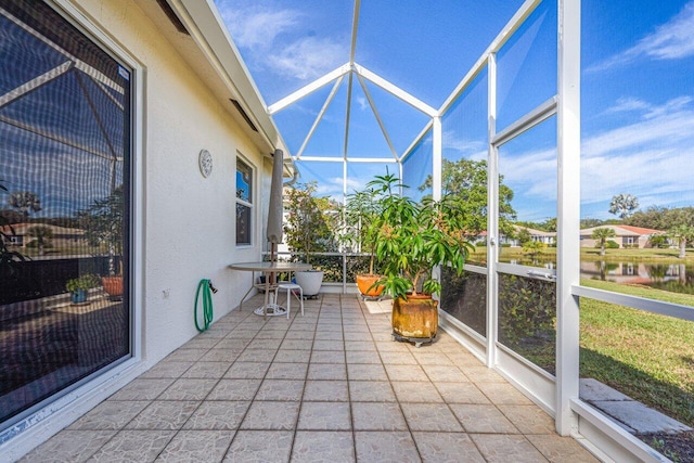 sunroom with plenty of natural light and a water view