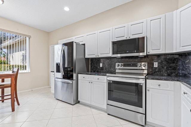 kitchen with backsplash, white cabinets, and appliances with stainless steel finishes