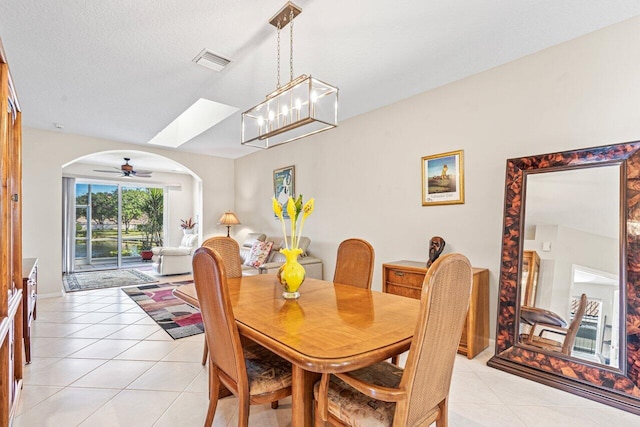 tiled dining space with a textured ceiling