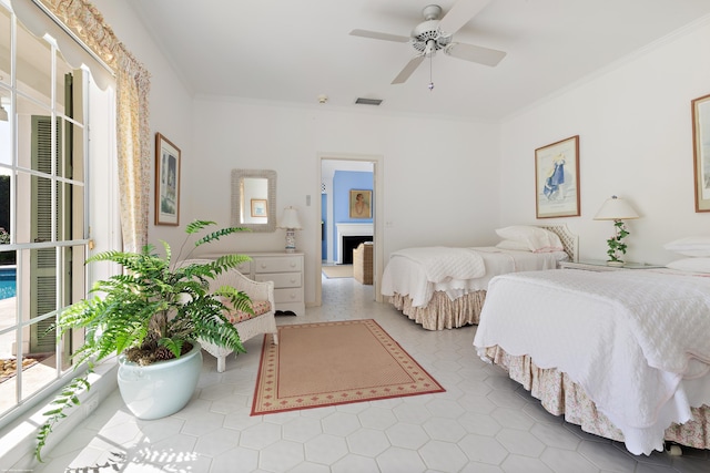 tiled bedroom with ceiling fan and ornamental molding