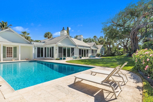 view of swimming pool with a yard and a patio