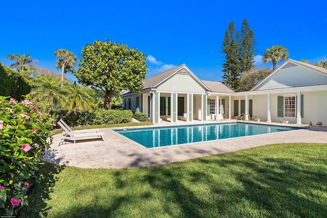 view of pool featuring a patio and a yard